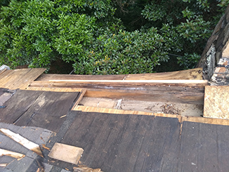 Tree limb caused damage to roof in Marietta and required wood and shingle repair 